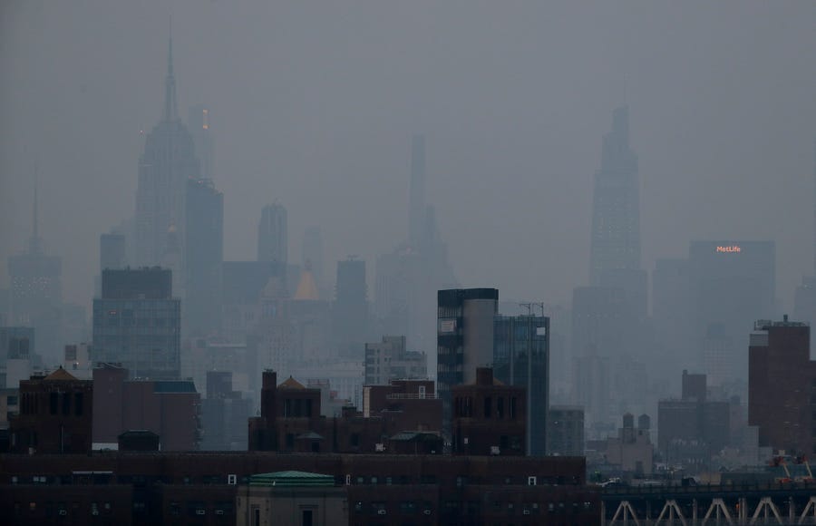 A thick haze hangs over Manhattan, Tuesday, July 20, 2021, in New York. Wildfires in the West are creating hazy skies as far away as New York as the massive infernos spew smoke and ash into the air in columns up to six miles high.