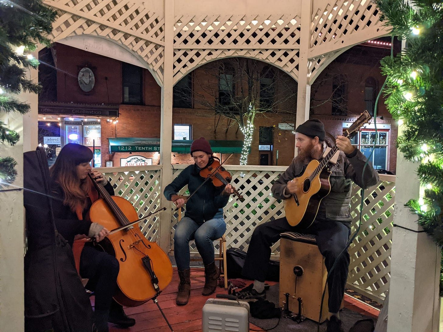 A cellist, a fiddler, and a guitarist, playing in the gazebo in Fairhaven A cellist, a fiddler, and a guitarist, playing in the gazebo in Fairhaven