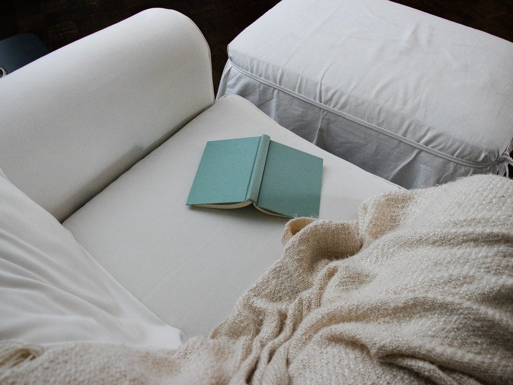 white book on white bed