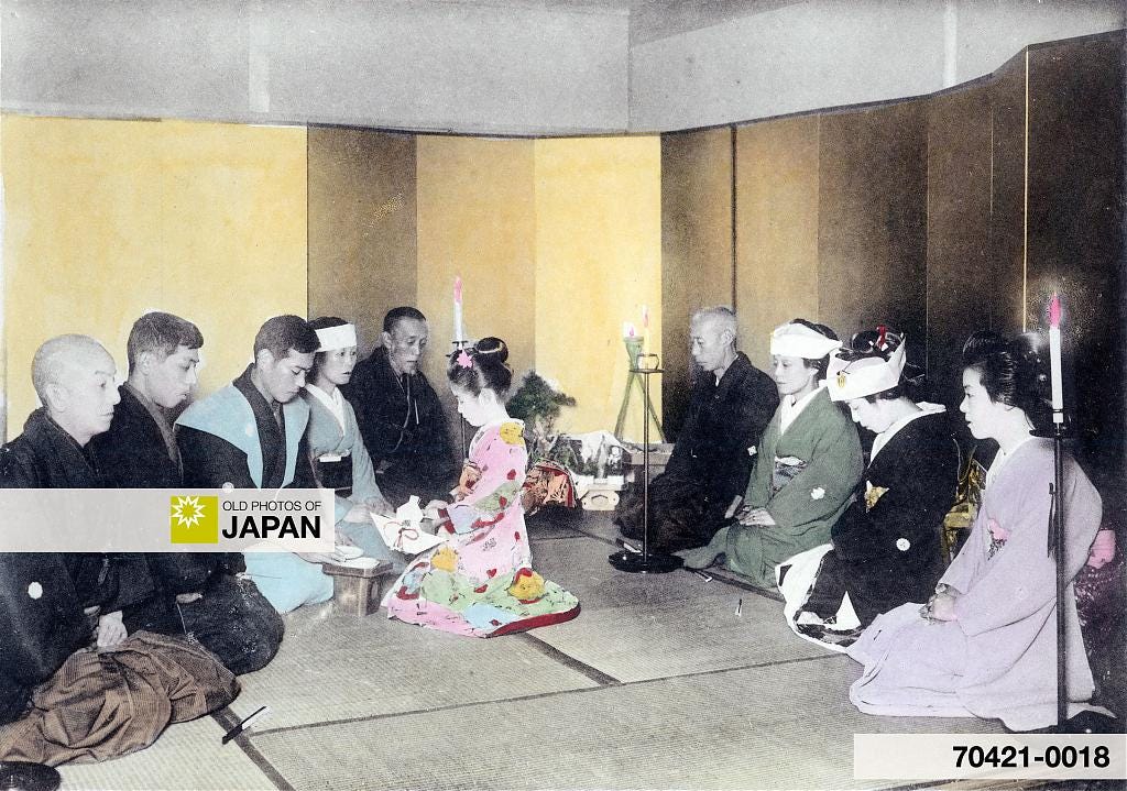 Family members drink ceremonial sake during a Japanese wedding, 1905