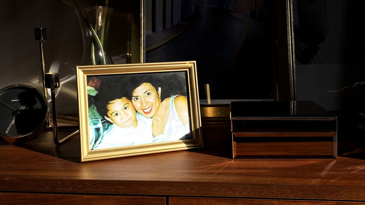 Cover Photo: photograph of a gold-framed photograph of the author as a child, with his mother, on a shelf also containing a clock and a wooden jewelry box with a vase and framed art behind