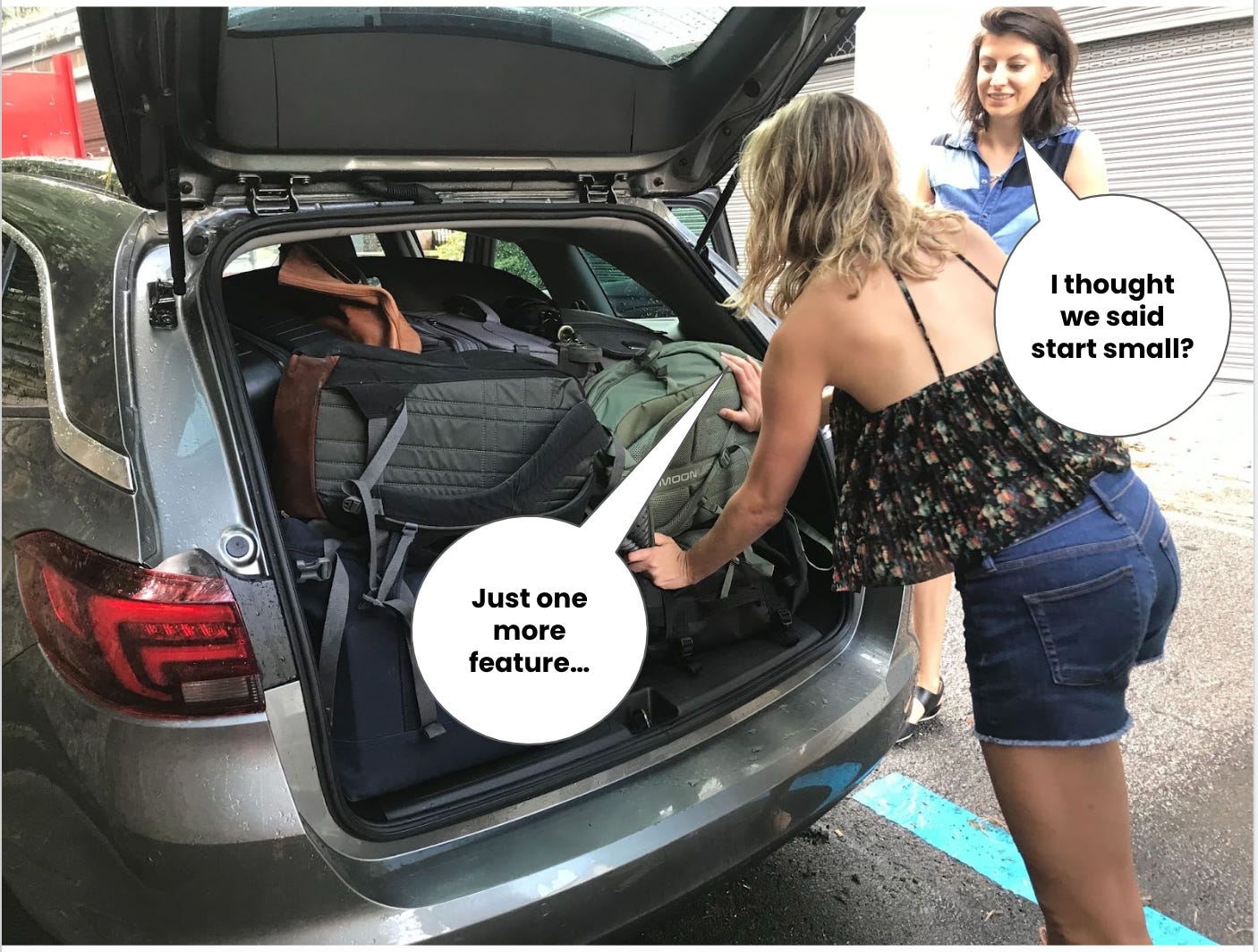 Kasia and Jean Ellen stand in front of a stuffed car trunk. Jean Ellen's text bubble: "Just one more feature." Kasia's text bubble: "I thought we said start small?"