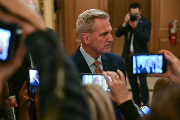 Representative Kevin McCarthy speaks to reporters in the Capitol while they film in on mobile phones.