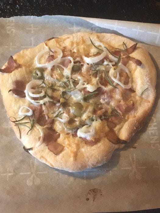 Newberry, homemade pizza with bacon, shallots, marinated olives, fresh rosemary, cream, and touch of cheddar