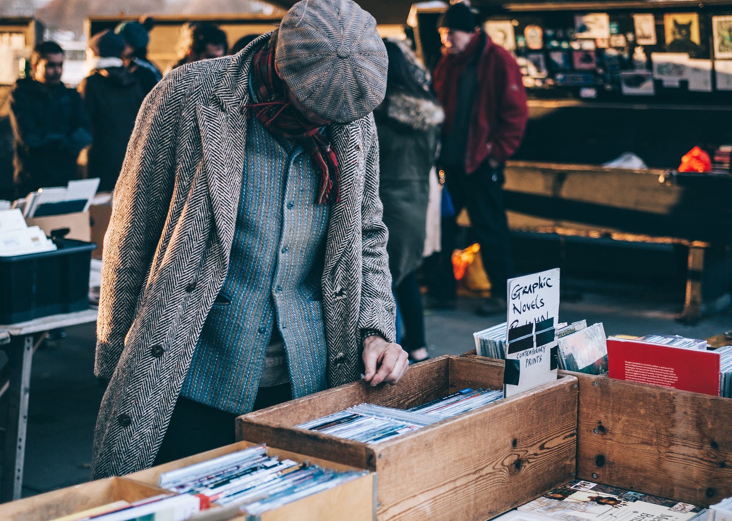 person looking in box filled with books photo