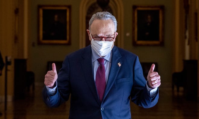 Senate Majority Leader Sen. Chuck Schumer, D-N.Y., gives a thumbs up after leaving the Senate chamber at the U.S. Capitol on March 6, 2021 in Washington.
