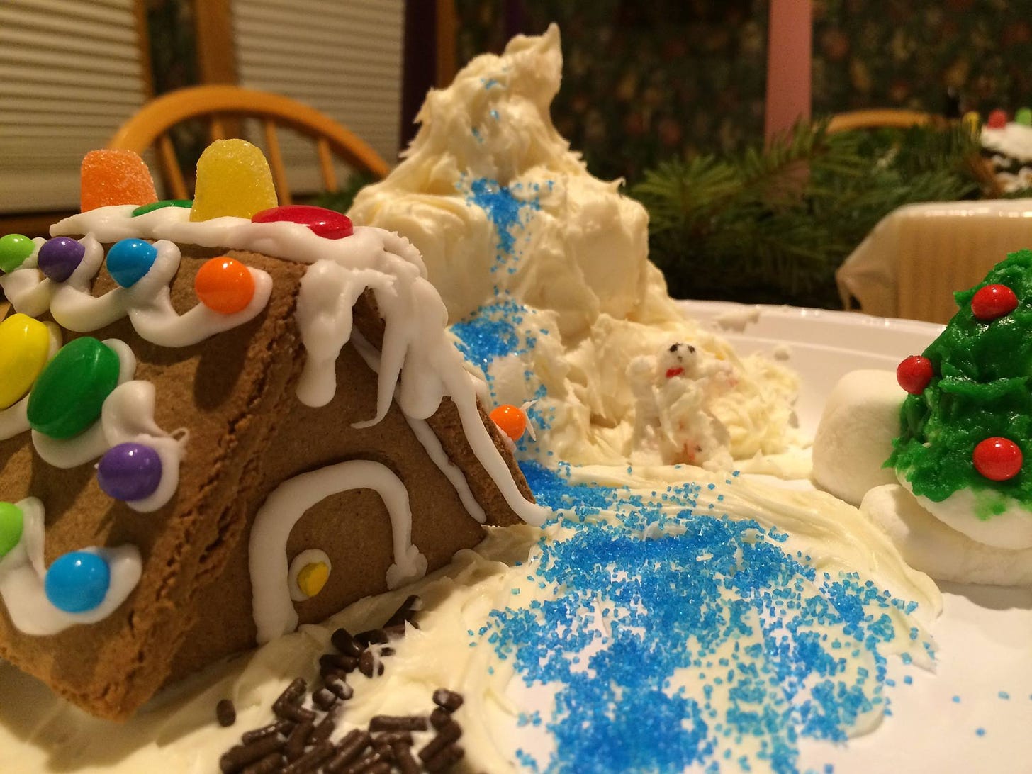 a gingerbread house, at the foot of a marshmallow mountain