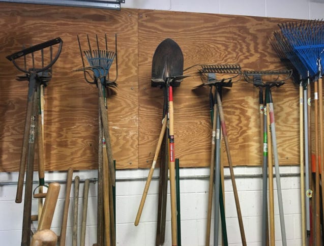 garden tools hung on wall