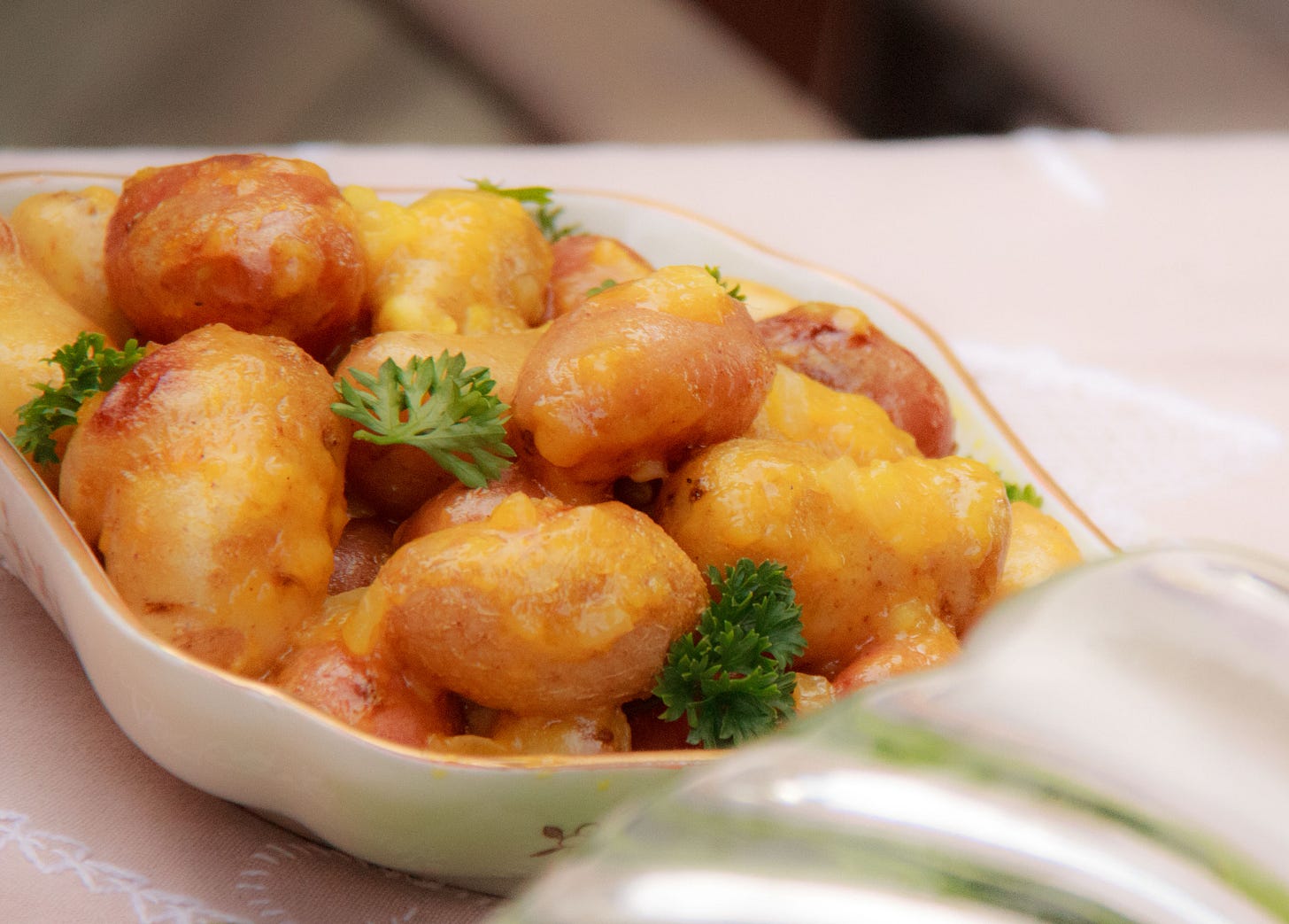 Photos shows a bowl of Fingerling Potatoes with Orange-Prosecco Butter. Adapted from Mango by Jen Karetnick (University Press of Florida, 2014). Photo Credit: V Sands Photography