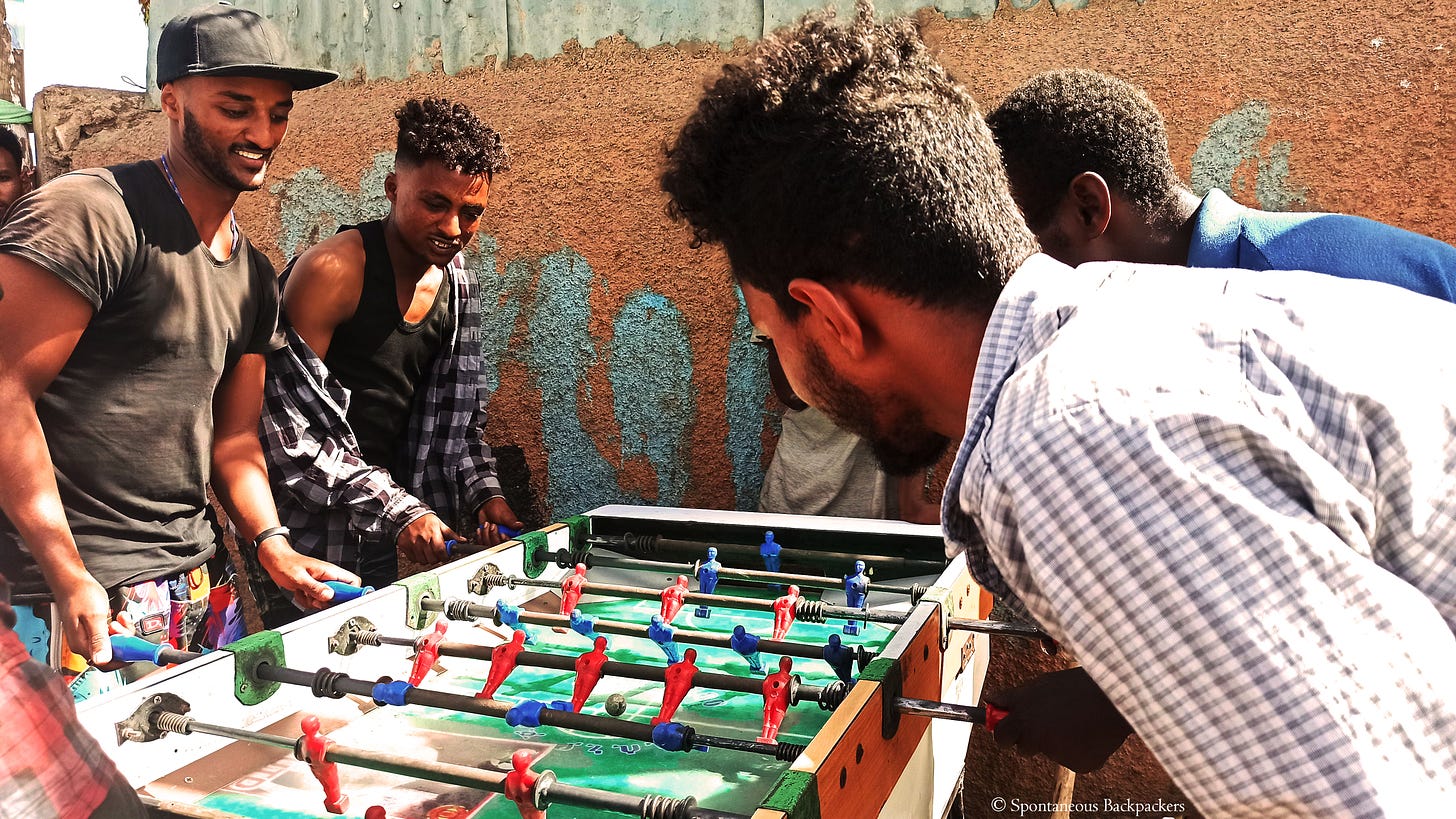 Spontaneous Backpackers playing foosball in Ethiopia