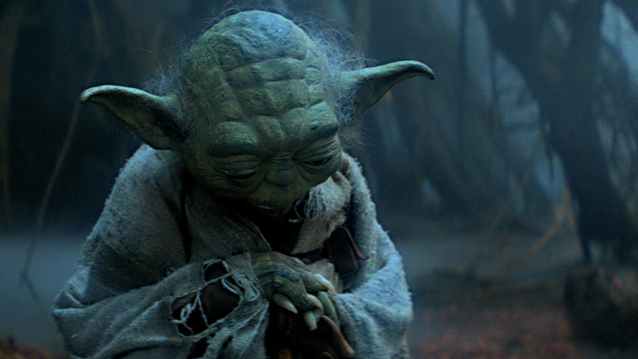 Yoda with his head bowed, looking sort of disappointed