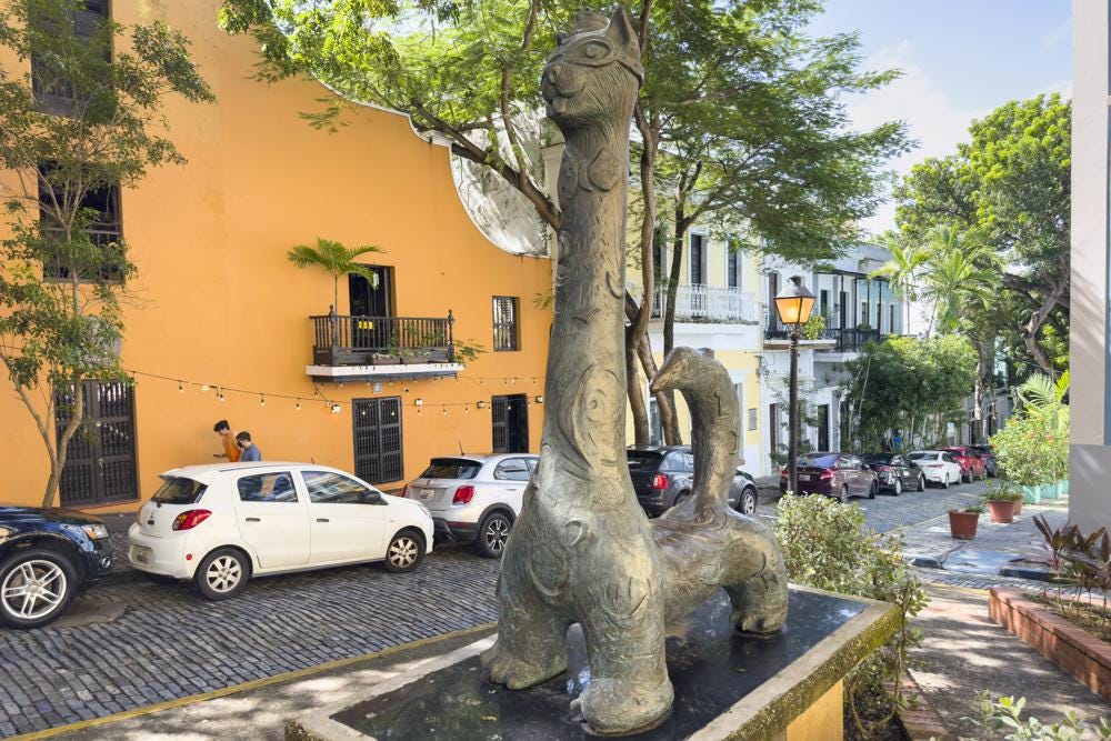 A statue of a cat stands in Old San Juan, Puerto Rico, Thursday, Nov. 3, 2022. Cats have long strolled through the cobblestone streets of the historic district and are so beloved they even have their own statue in Old San Juan.  (AP Photo/Alejandro Granadillo)