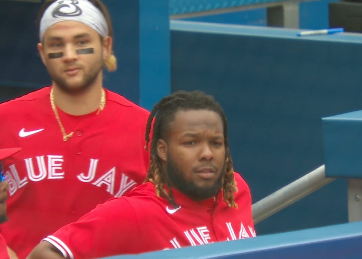 A frustrated Bo Bichette and Vladimir Guerrero Jr. look out from the Blue Jays' dugout.