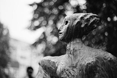 May be a black-and-white image of sculpture, outdoors and monument