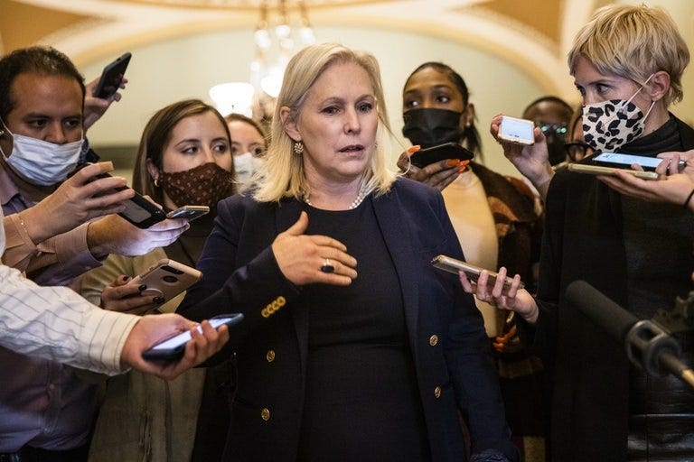 Senator Kirsten Gillibrand is surrounded by reporters as she walks through Capitol Hill.