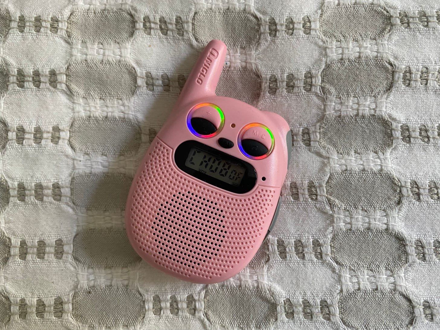 A pink walkie talkie, shaped like a cat.
