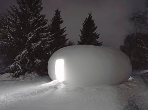 an igloo with a white light emitting from it