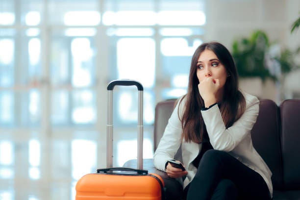 Sad Melancholic Woman with Suitcase in Airport Waiting Room Upset girl traveling along waiting for the next flight vacation depression stock pictures, royalty-free photos & images
