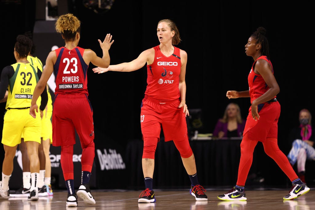 PALMETTO, FL- JULY 30: Aerial Powers #23 high-fives Emma Meesseman #33 of the Washington Mystics on July 30, 2020 at Feld Entertainment Center in Palmetto, Florida.