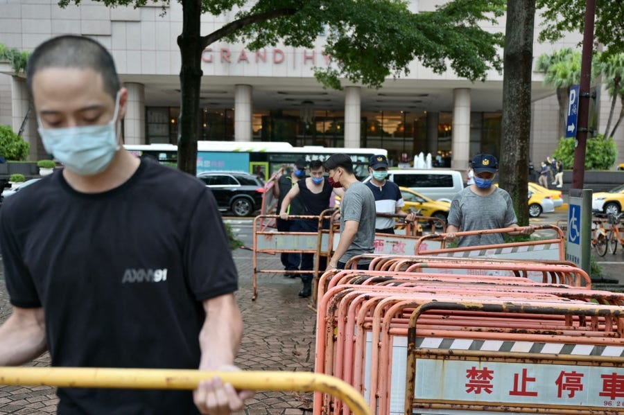 Workers build a security zone outside a local hotel in Taipei on August 2, 2022, where US House Speaker Nancy Pelosi might be staying.