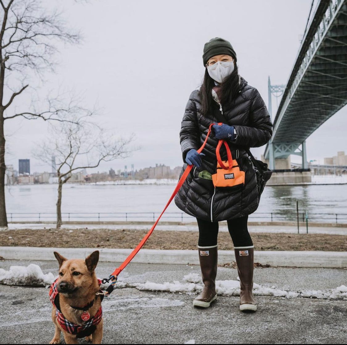 Mochi and me, looking very happy, posing for a photo in a park with snow on the ground.