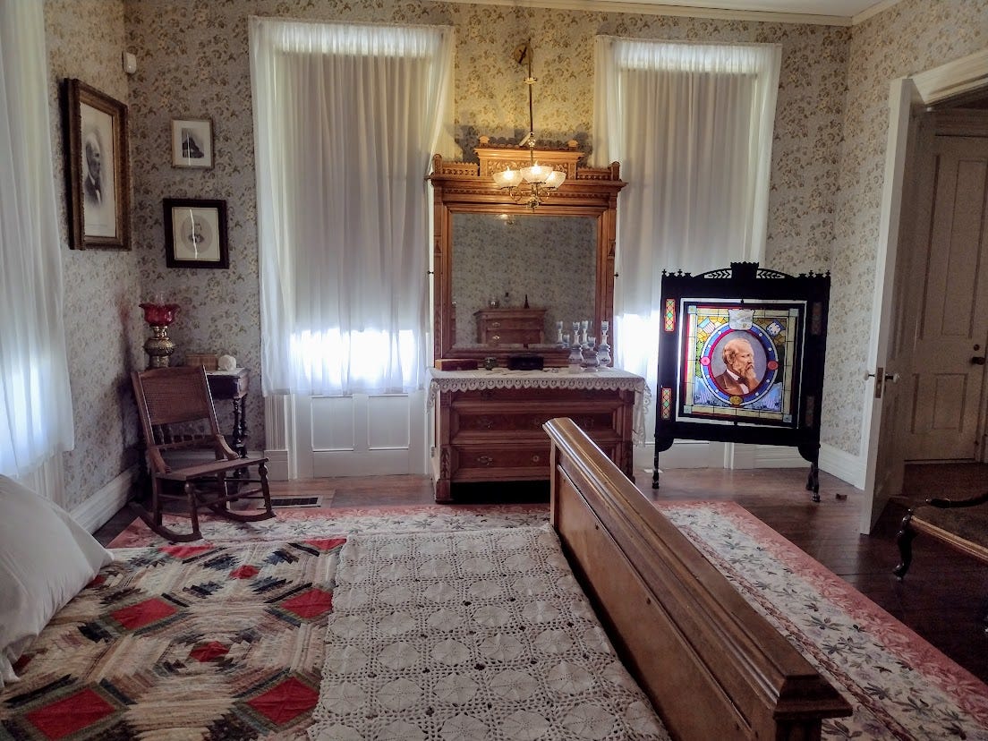 Victorian bedroom with Garfield firescreen, and other pictures of Garfield hanging from the wall