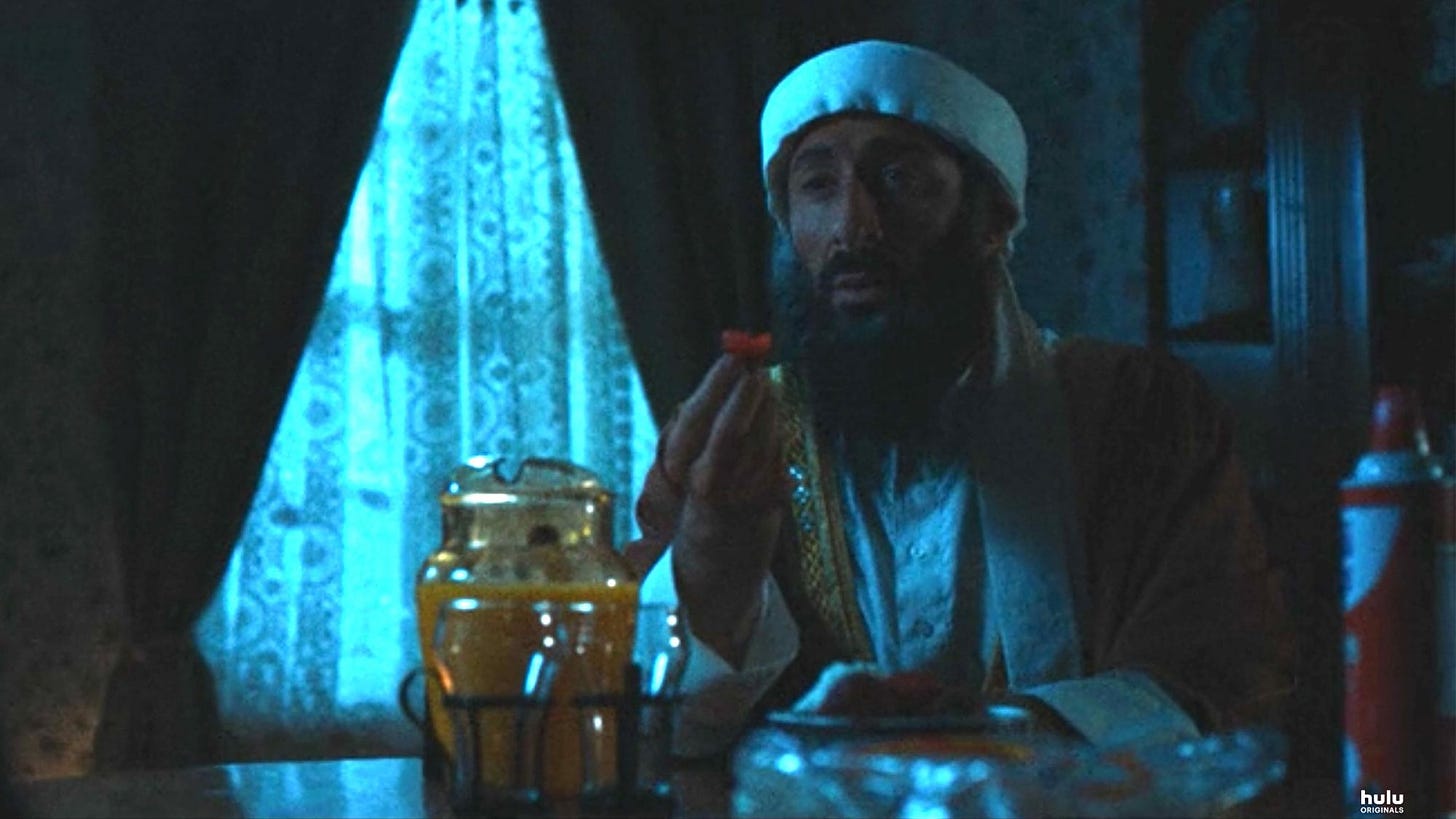 this is a screenshot of the hulu tv show ramy in the episode "strawberries." an actor playing osama bin laden has just taken a bite of a strawberry. it's a really good episode. this is a 9/11 post and i didn't want to just have another pic of the towers burning so i do this instead