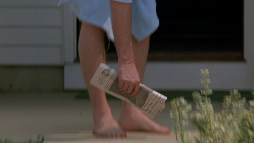 Still from Goodfellas ending of Henry Hill picking up newspaper