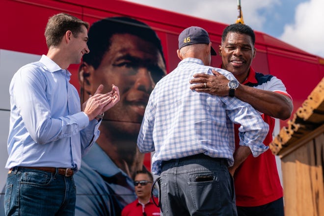 Republican Senate candidate Herschel Walker embraces Sens. Rick Scott and Tom Cotton at a campaign rally on Oct. 11, 2022, in Carrollton.