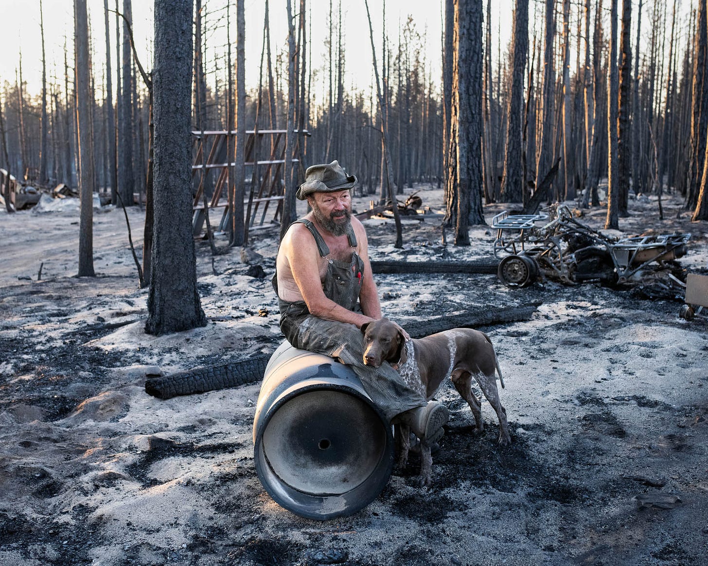 Jeff Whited sits among his destroyed belongings on July 22. The Bootleg Fire arrived “just like a freight train,” says Whited. “It looks like a freaking bomb went off.” The 63-year-old had been helping clean up the wreckage of his brother’s burned-down house when flames reached his own. Guitars and amplifiers, snowmobiles and trucks, engine parts, chain saws, a huge cache of hand tools and much more—all gone, Whited says. “This sure was a beautiful place,” he says. “It doesn’t leave a beautiful memory with me, not this picture of it.” At the grave of his partner on his 12-acre property, wind chimes used to hang in the trees. Whited recalls asking why she wanted so many of them, to which she replied, “When I'm gone, baby, you’ll know I’m still there when you hear ’em.” After the fire, he says, “I can’t hear one. They’re gone. Every wind chime.”
