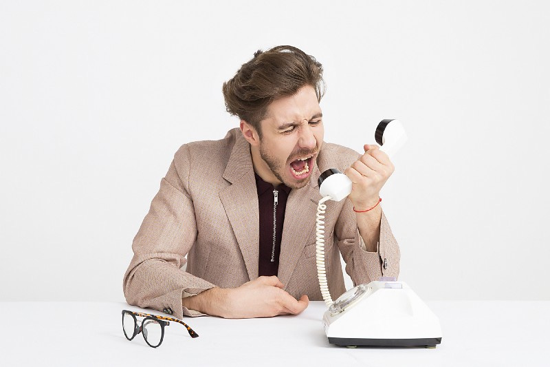 A man shouting on the phone