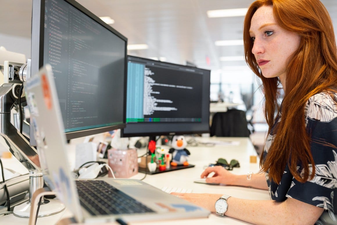 Woman coding on computer - Agile Process in Software Engineering