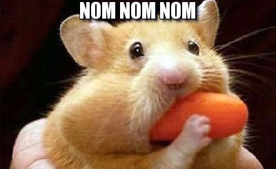 Hamster stuffing himself with a carrot
