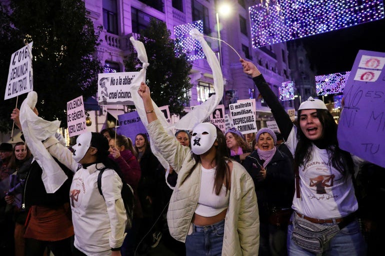 Demonstrators take part in a protest to mark the International Day for the Elimination of Violence against Women in Madrid