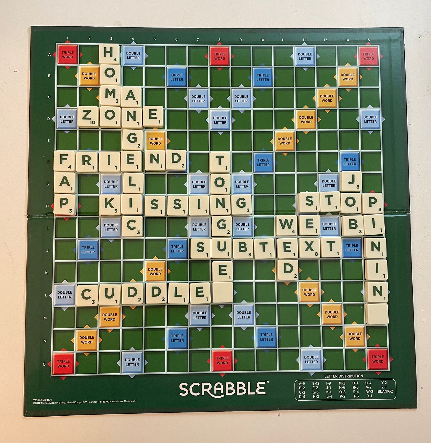 Scrabble board with words like CUDDLE SUBTEXT SEX STOP PINING BI WED HOMO FAP etc