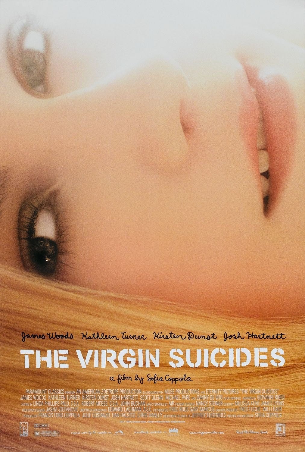 Poster for The Virgin Suicides, showing a girl's face as she lies facing the camera in close up. Light washes out the top of the picture. The text about the movie is at the bottom.