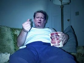 Al Gore looking sad and eating ice cream