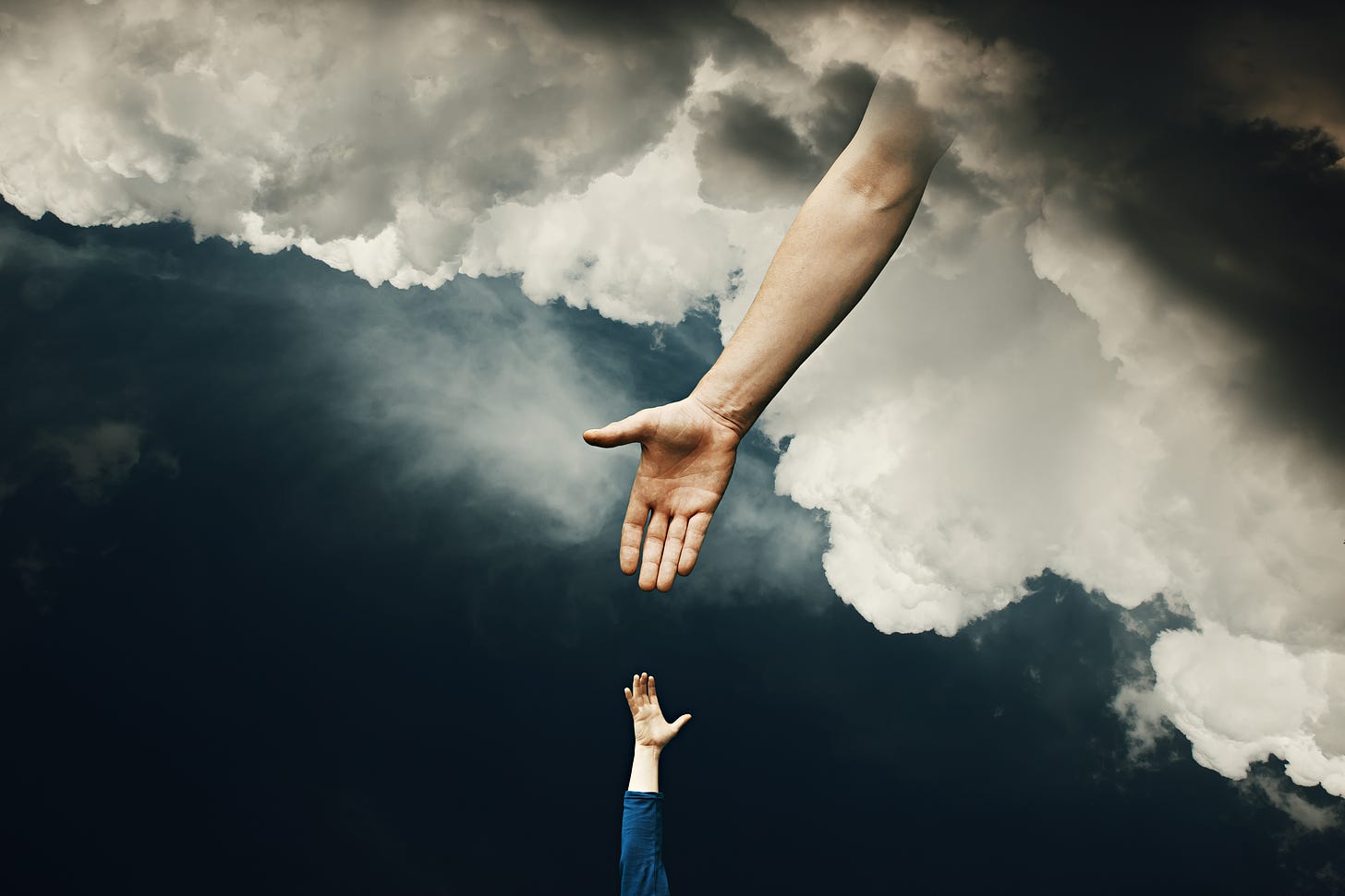in a stormy blue sky there are gray clouds. out of the sea a small hand rises up. a larger hand reaches down from the clouds. both hands are white