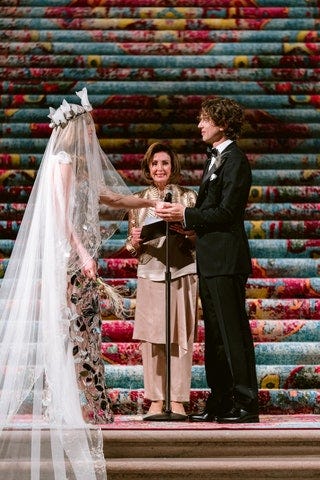 Nancy Pelosi offers a rictus of simulated joy to the rich children as they say their vows in front of a set of steps covered with a carpet that all by itself cost more money than most of us will ever see in our lives. 