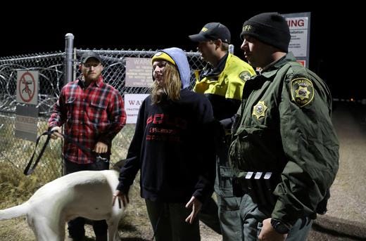 A woman is detained by law enforcement after crossing into Area 51. Reuters. September 20, 2019 09:14am EDT
