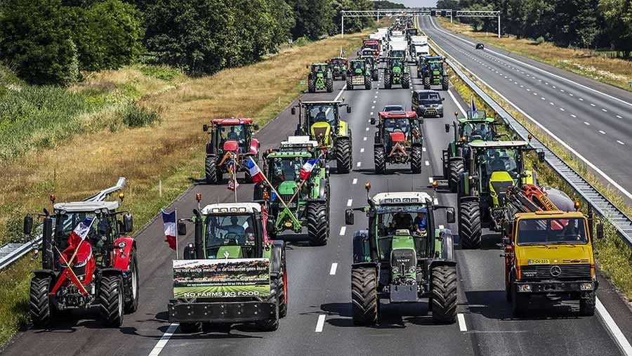A convoy of tractors across a motorway