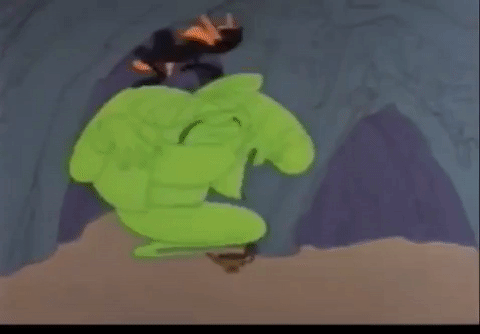 A gif of a clip from "Ali Baba Bunny", where Daffy is stuffing the genie back into his lamp