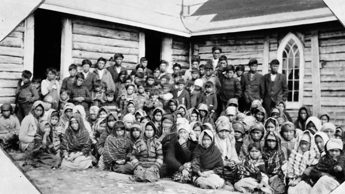 Group of Indigenous children in front of Indian Day School in Ontario.