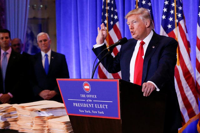 Vice President-elect Mike Pence is seen in the background as U.S. President-elect Donald Trump speaks during a press conference in Trump Tower, Manhattan, New York, on  Jan. 11, 2017. (Shannon Sta ...