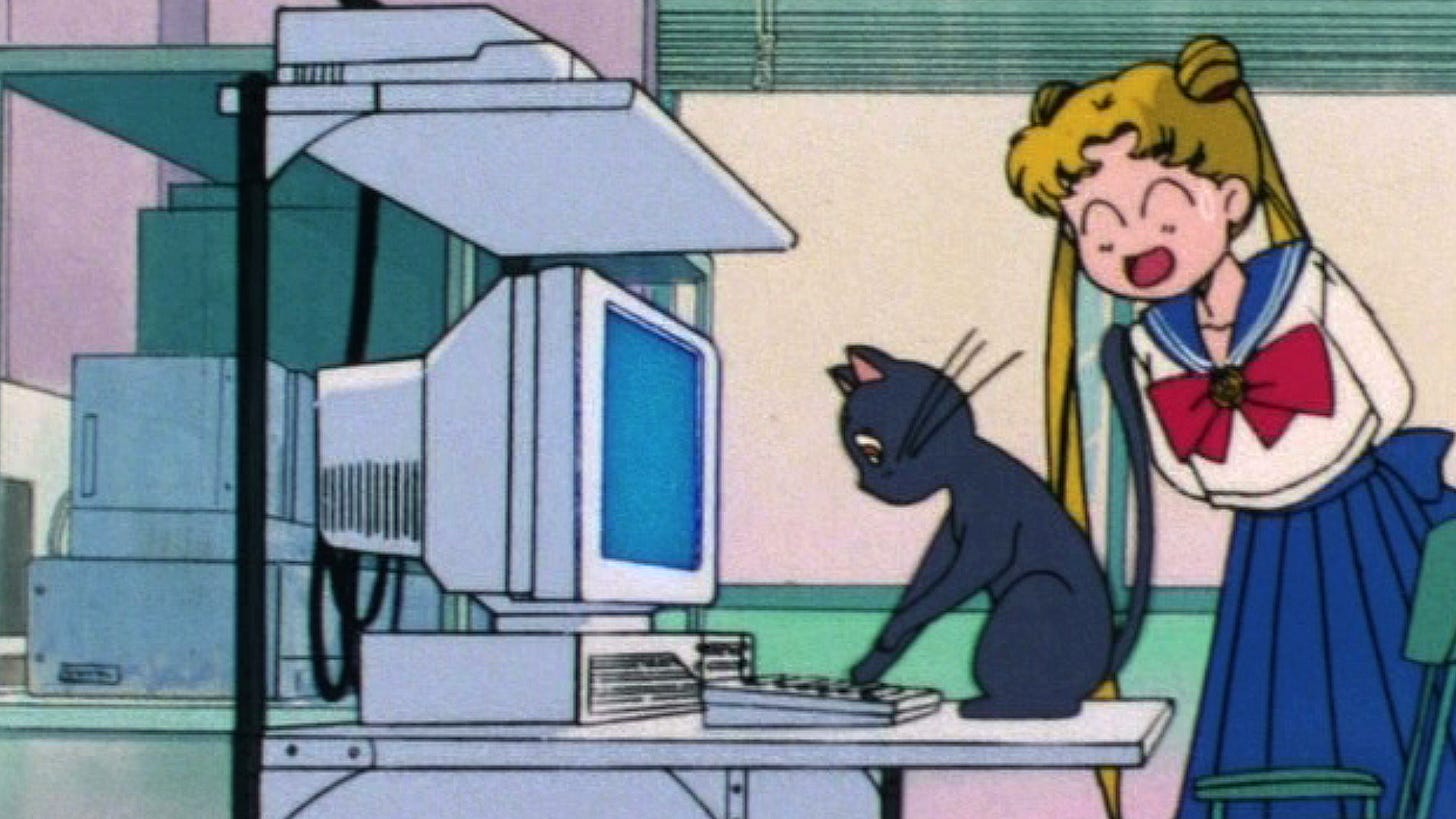 90s anime Luna and Serena Usagi on a computer in Sailor Moon