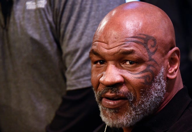 In this file photo taken on November 05, 2021, Mike Tyson attends the weigh-in for boxers Canelo Alvarez and Caleb Plant in Las Vegas. Tyson repeatedly punched a passenger on a plane about to fly out of San Francisco after reportedly becoming irritated by the man's attempts to talk to him.