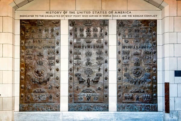 Bronze panels with raised symbols adorn an entrance to a hall at the U.S. Military Academy at West Point.