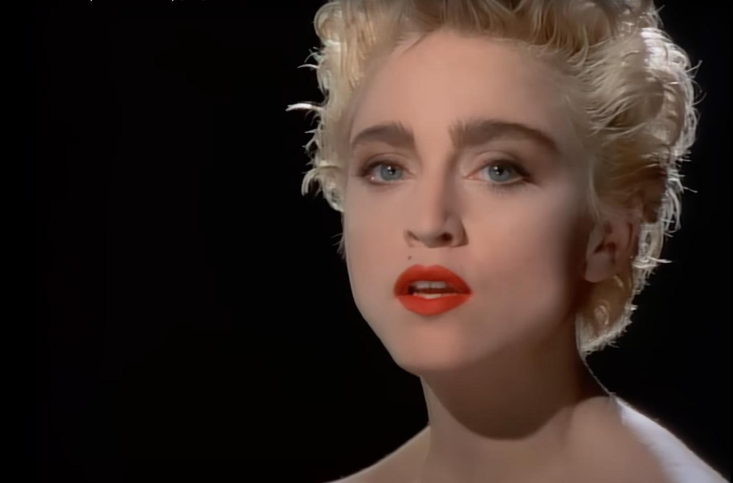 Screenshot of Madonna in the video, closeup.