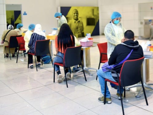 Emirates passengers given a quick blood test by the Dubai Health Authority in the check-in area at Dubai International Airport.