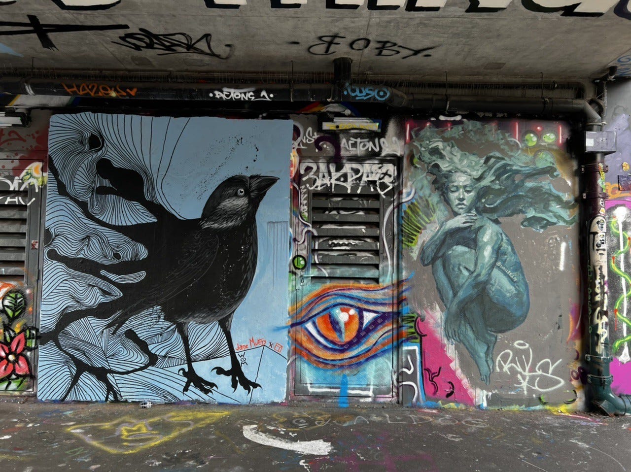 Street art of a crow and woman in Shoreditch, London
